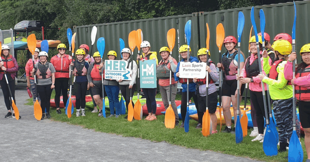 Group of women holding oars before going kayaking