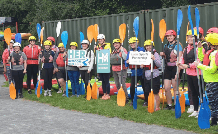 Group of women holding oars before going kayaking