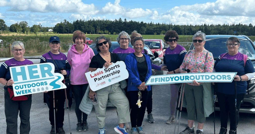 Group of women outside holding signs for Her Outdoors Week and Laois Sports Partnership