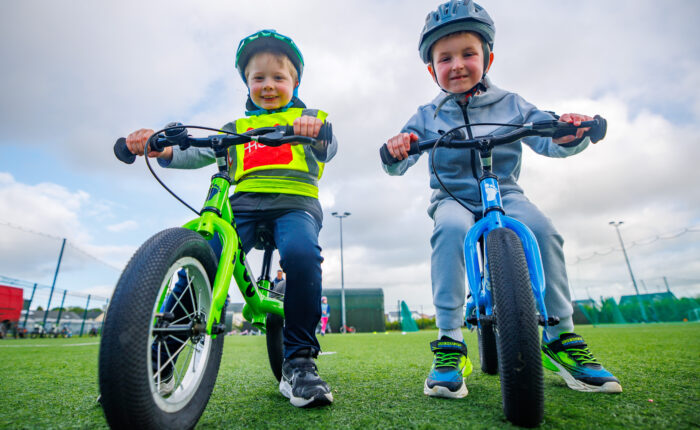 Image of two children learning how to cycle