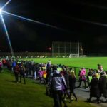 Image of a group of people walking on track at a GAA pitch