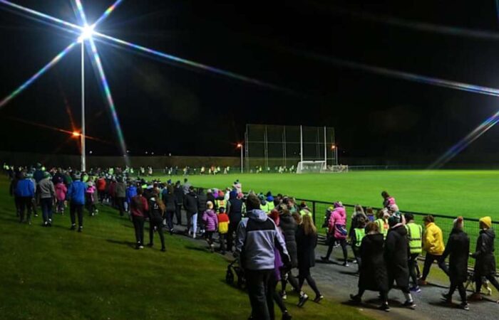 Image of a group of people walking on track at a GAA pitch